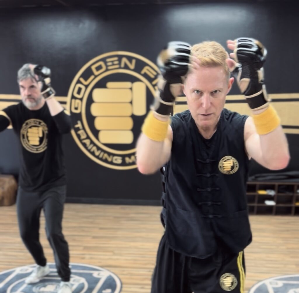Sifu Jonny Blu Klamer demonstrating a guarded striking drill with Golden Fist training gloves