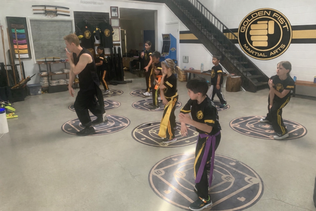 Sifu Jonny Blu leads a kids martial arts class on Golden Fist Training Circles in the Burbank studio.