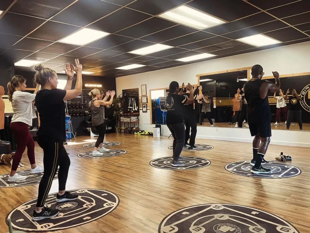 Adults practicing Golden Fist fitness training.
